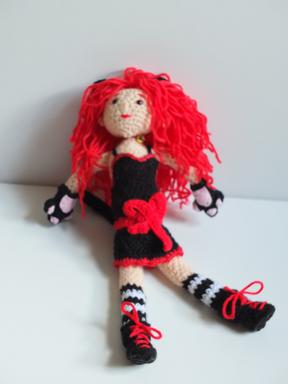 The doll sitting against a white background